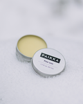 Paikka honey paw wax jar designed to protect dog paw pads from hot pavement and rough urban surfaces