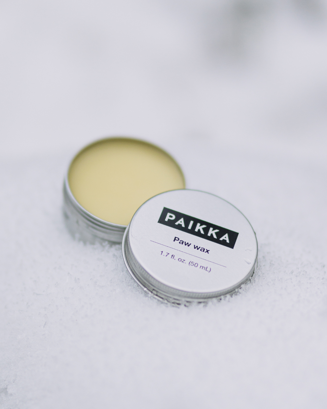 Paikka honey paw wax jar designed to protect dog paw pads from hot pavement and rough urban surfaces