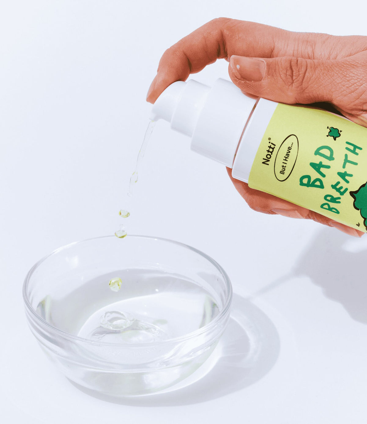 Close-up of Notti Bad Breath liquid being pumped into a bowl of water