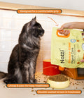 Cat watching Notti Crunchy-Baked Digest Care kibble poured from the pouch's easy-grip spout into a bowl