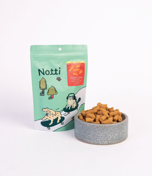 Notti Joint Care Beef & Salmon Freeze-Dried Chunks, 50g pouch beside a bowl of chunks