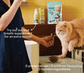Cat taking a Notti Dental Crunch treat from its owner's hand, with the pouch and Notti Bad Breath additive on the shelf. No preservatives or artificial flavouring